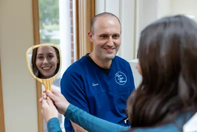 Cosmetic Dentistry in North Royalton, OH Shows happy dental implant patient with Dr. Sala, our dentist.